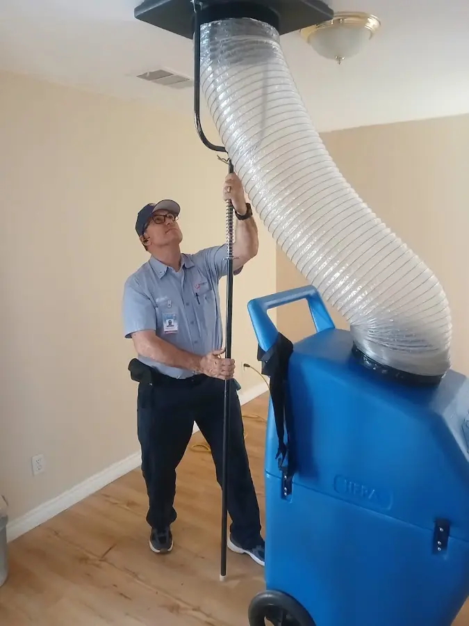 Furnace Tune-Up technician using HEPA equipment in Allen Park